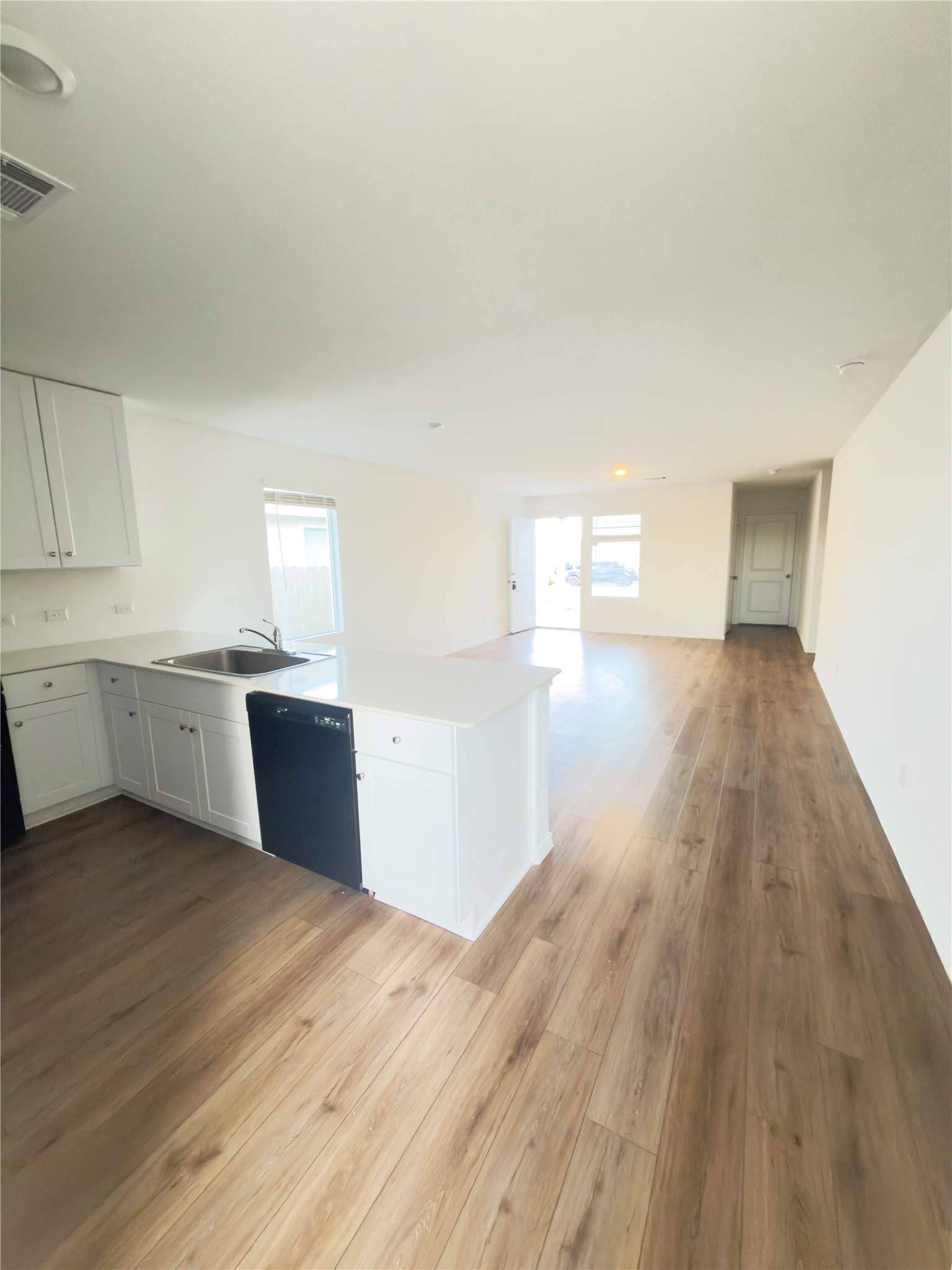 13336 Illumination Road Elgin, TX 78621 - Photo 2 of 15 a view of a kitchen with wooden floor and windows