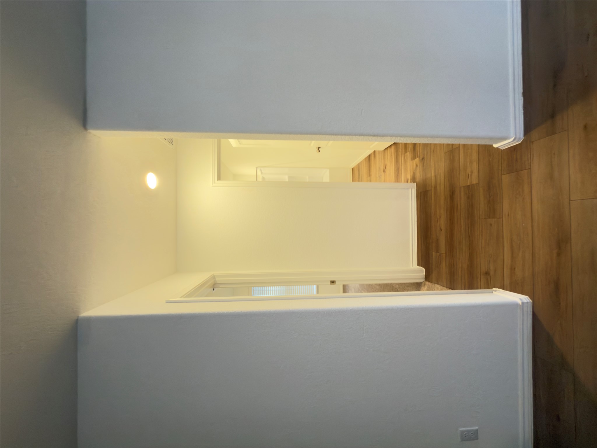 13336 Illumination Road Elgin, TX 78621 - Photo 3 of 15 a view of an empty room with wooden floor and a window