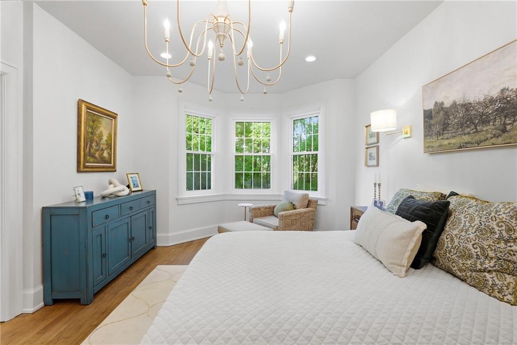 3944 Bakerstown Road Gibsonia, PA 15044 - Photo 33 of 50 a spacious bedroom with a bed and a chandelier