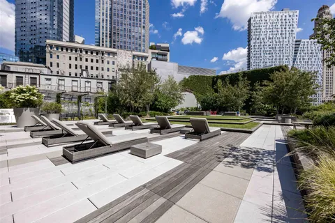 a view of swimming pool with outdoor seating and plants