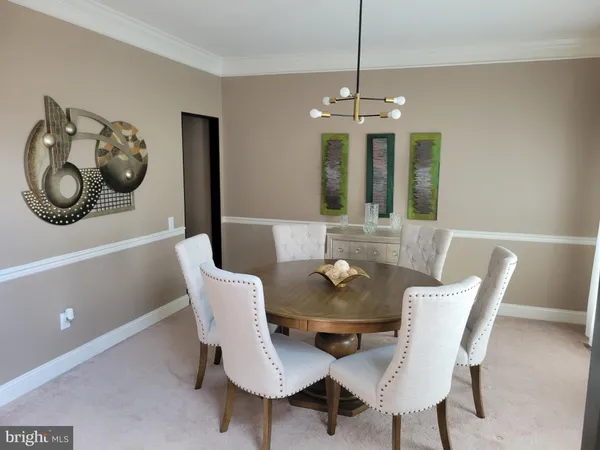 a view of a dining room with furniture chandelier and wooden floor