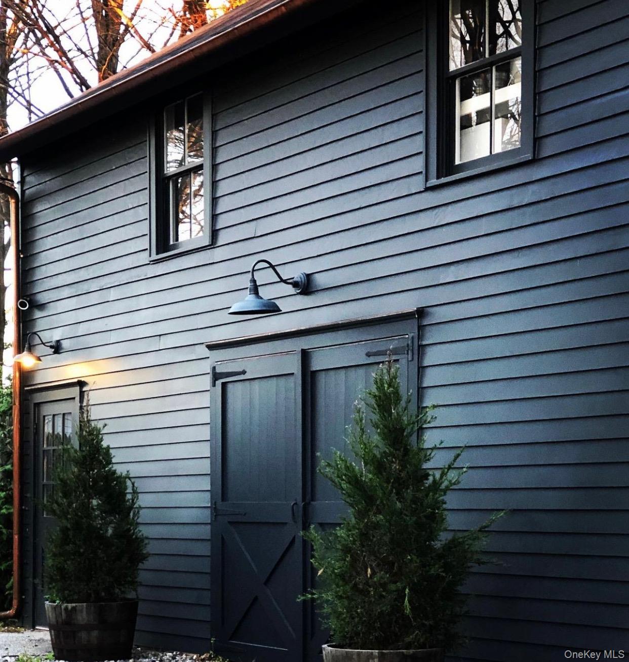 259 Westchester Avenue Pound Ridge, NY 10576 - Photo 18 of 21 a view of a house with a yard and potted plants