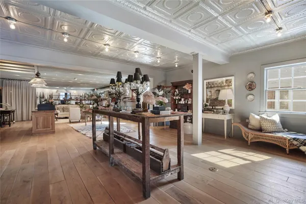 a view of a living room and kitchen with furniture