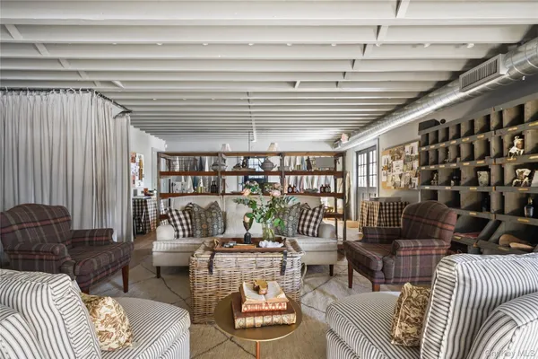 a living room with furniture and a book shelf