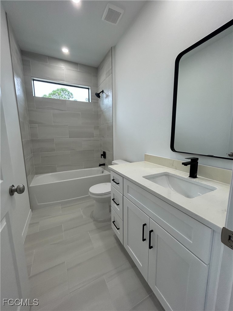 449 Bell Boulevard Lehigh Acres, FL 33974 - Photo 15 of 21 a bathroom with a double vanity sink toilet mirror and shower