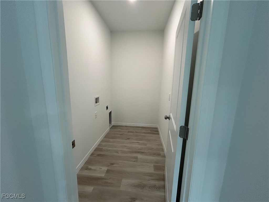 449 Bell Boulevard Lehigh Acres, FL 33974 - Photo 18 of 21 a view of a hallway with wooden floor