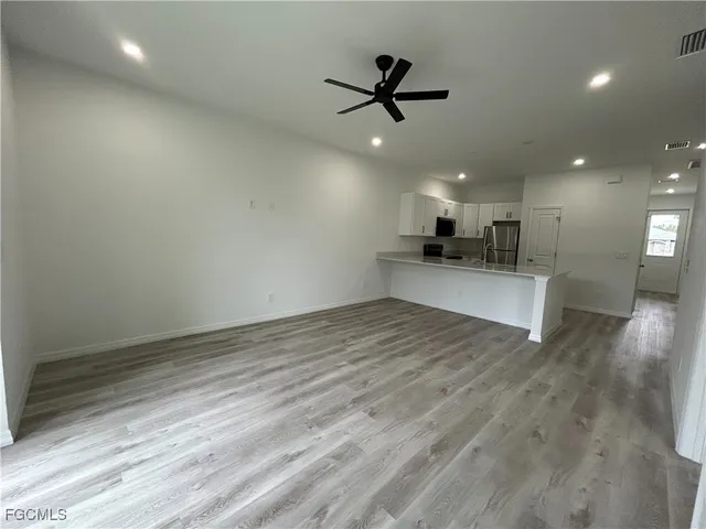 a view of a kitchen with a sink and wooden floor