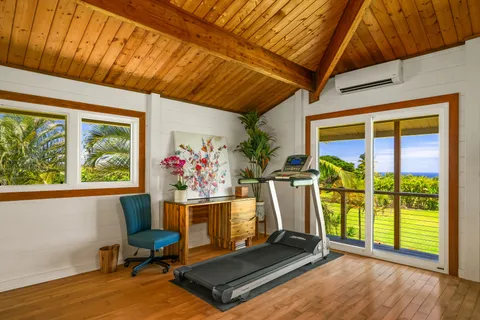 a view of a room with furniture and a window