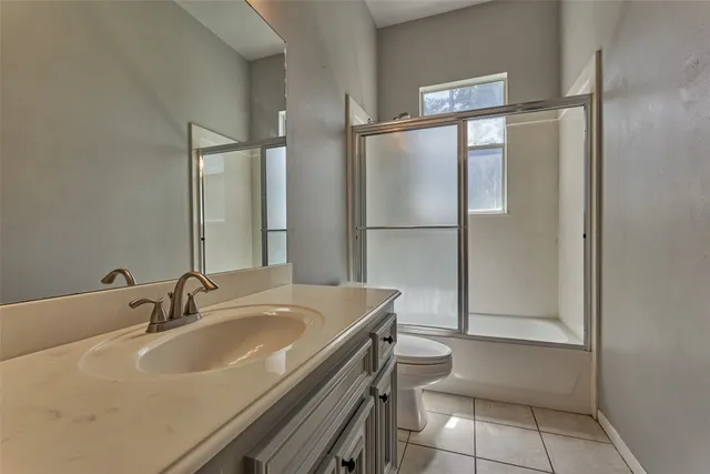 a kitchen with white cabinets and appliances