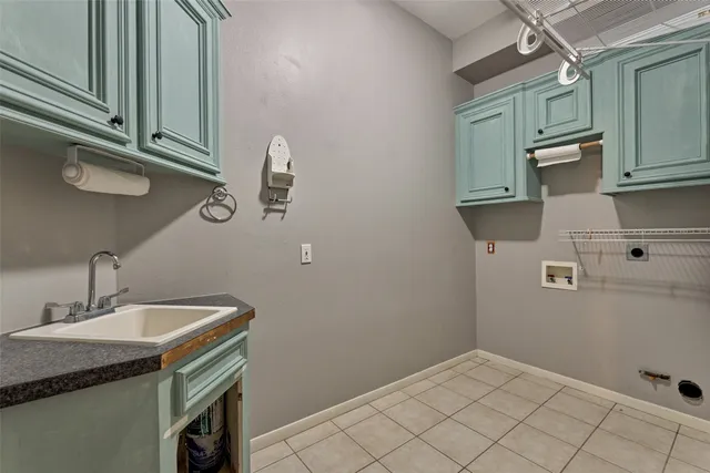 a view of an empty room with window and chandelier fan