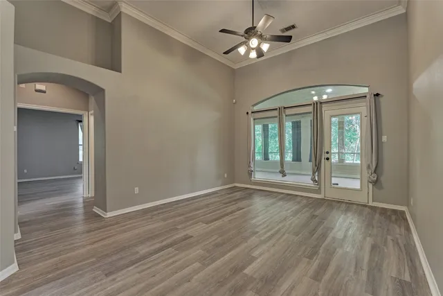 wooden floor in an empty room with a window
