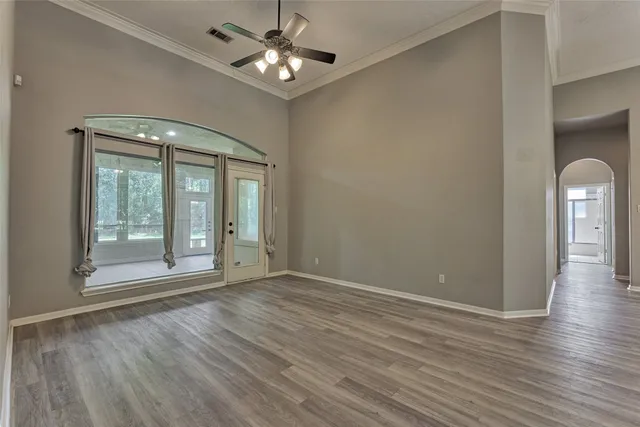 a view of empty room with wooden floor