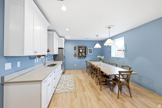 283 North 500 West Mapleton, UT 84664 - Photo 59 of 102 Kitchen featuring white cabinetry, light wood-type flooring, hanging light fixtures, and freestanding refrigerator