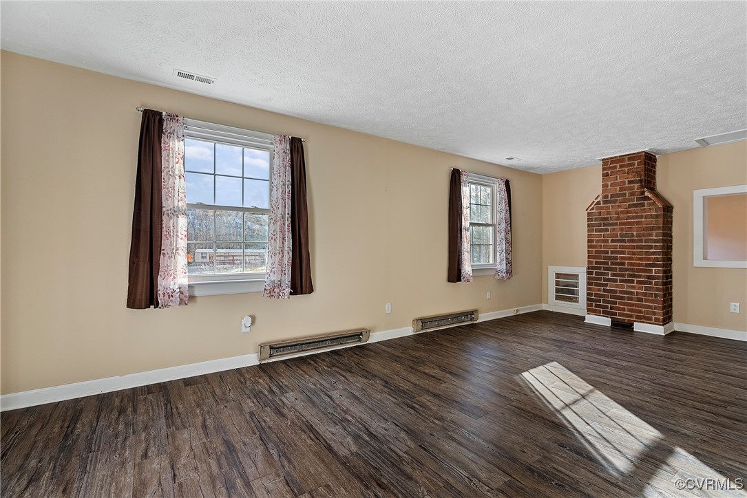 975 Windyknight Road Montpelier, VA 23192 - Photo 23 of 38 Unfurnished living room featuring a textured ceili
