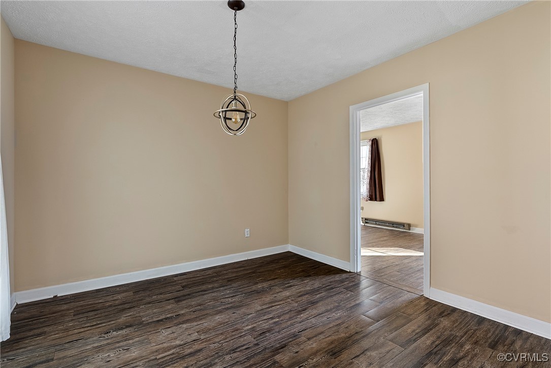 975 Windyknight Road Montpelier, VA 23192 - Photo 26 of 38 Spare room with a chandelier, dark wood-type floor