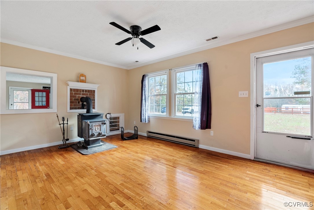975 Windyknight Road Montpelier, VA 23192 - Photo 6 of 38 Living room with a wood stove, baseboard heating,