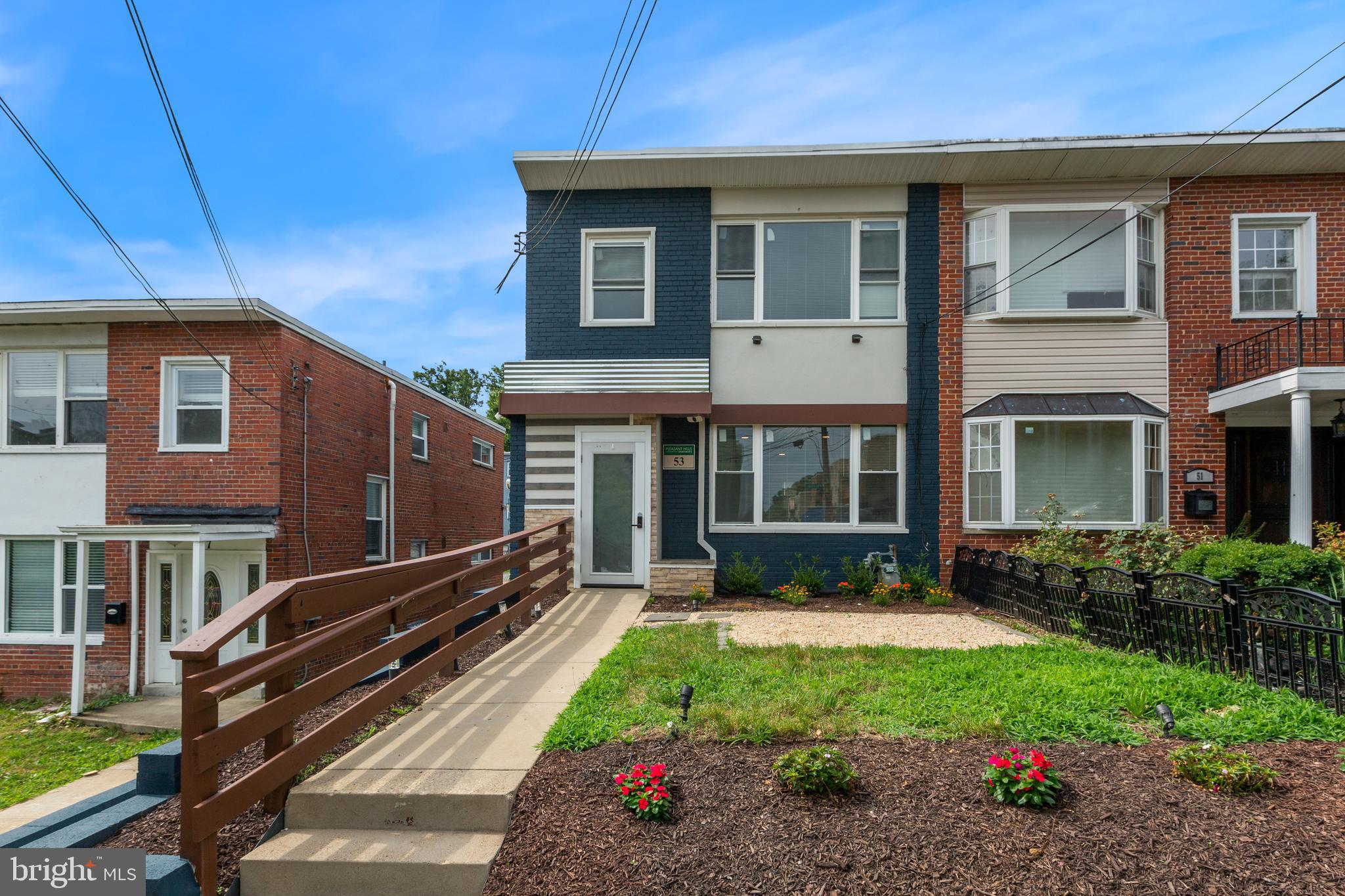 53 Victor Street Northeast, Unit 1 Washington, DC 20011 - Photo 1 of 18 a front view of a house with a yard