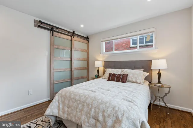 a bedroom with a bed and a night stand