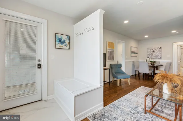 a living room with furniture a dining table and a refrigerator