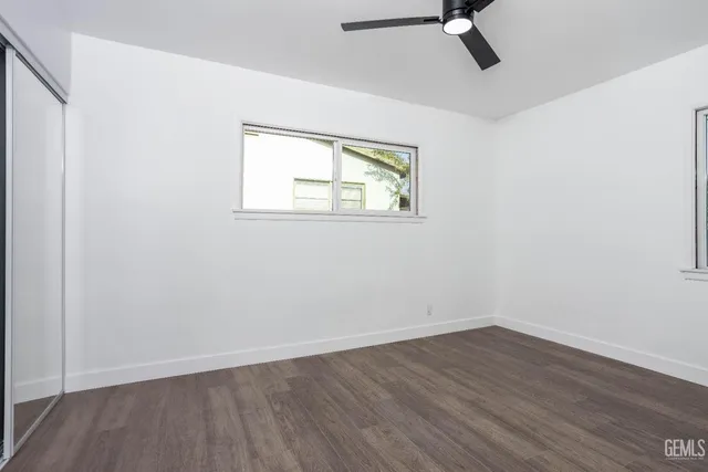 an empty room with wooden floor and closet