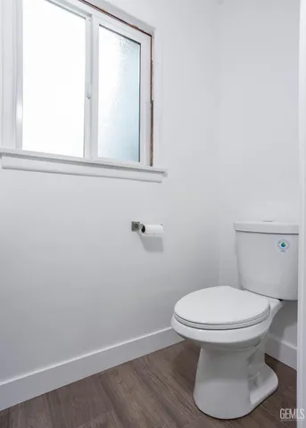 a bathroom with a white toilet sitting next to a bathroom sink and a shower