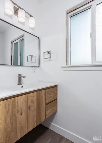 an empty room with wooden floor and a window