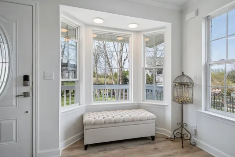 a bedroom with a bed and a large window