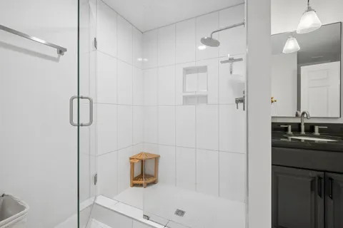 a bathroom with a shower and a sink