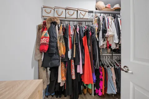 a view of walk in closet with clothes