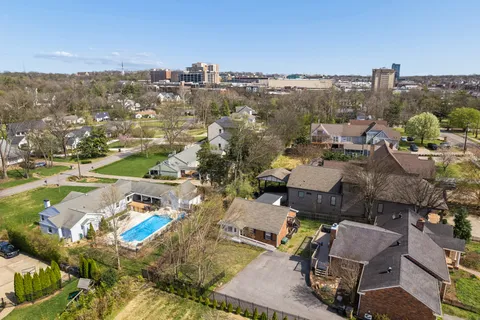 an aerial view of residential houses with city view