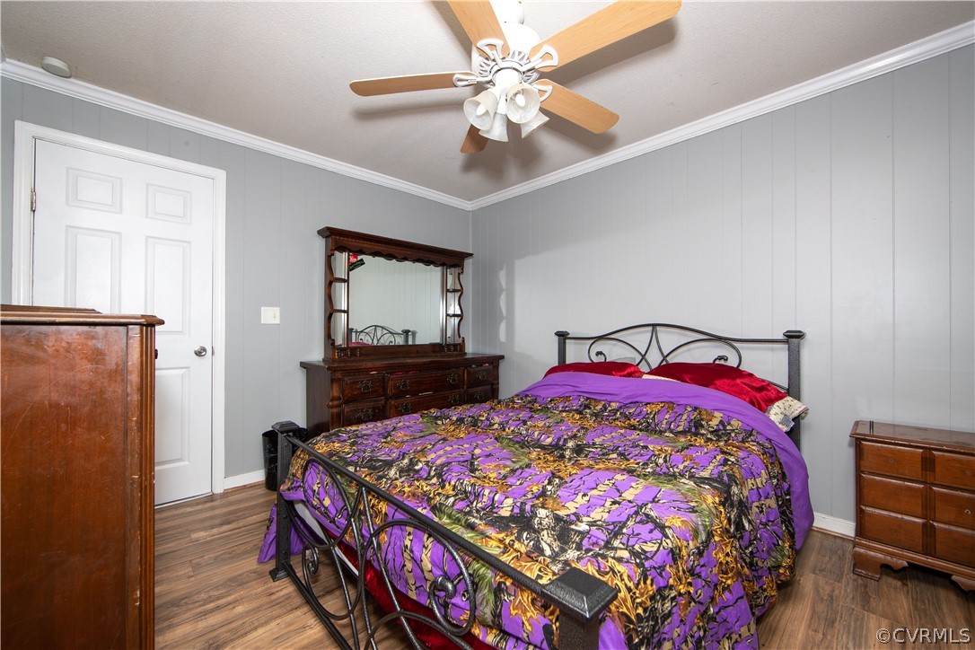 16907 Courthouse Road Dinwiddie, VA 23841 - Photo 15 of 15 a bedroom with a bed and a chandelier