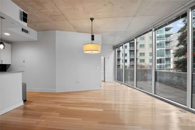 a view of a room with a ceiling fan and window
