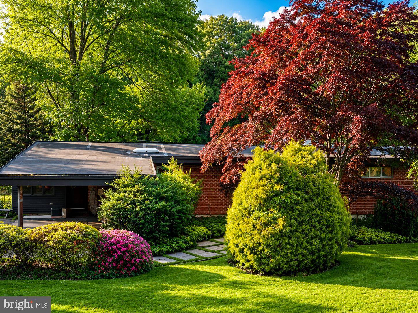 3228 Midfield Road Pikesville, MD 21208 - Photo 1 of 1 Lush greenery surrounds a charming home.