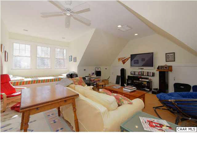 1441 Stillhouse Ridge Lane Charlottesville, VA 22903 - Photo 26 of 32 a living room with furniture a fireplace and a flat screen tv
