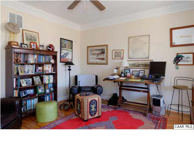 1441 Stillhouse Ridge Lane Charlottesville, VA 22903 - Photo 5 of 32 a living room with furniture a rug and a book shelf
