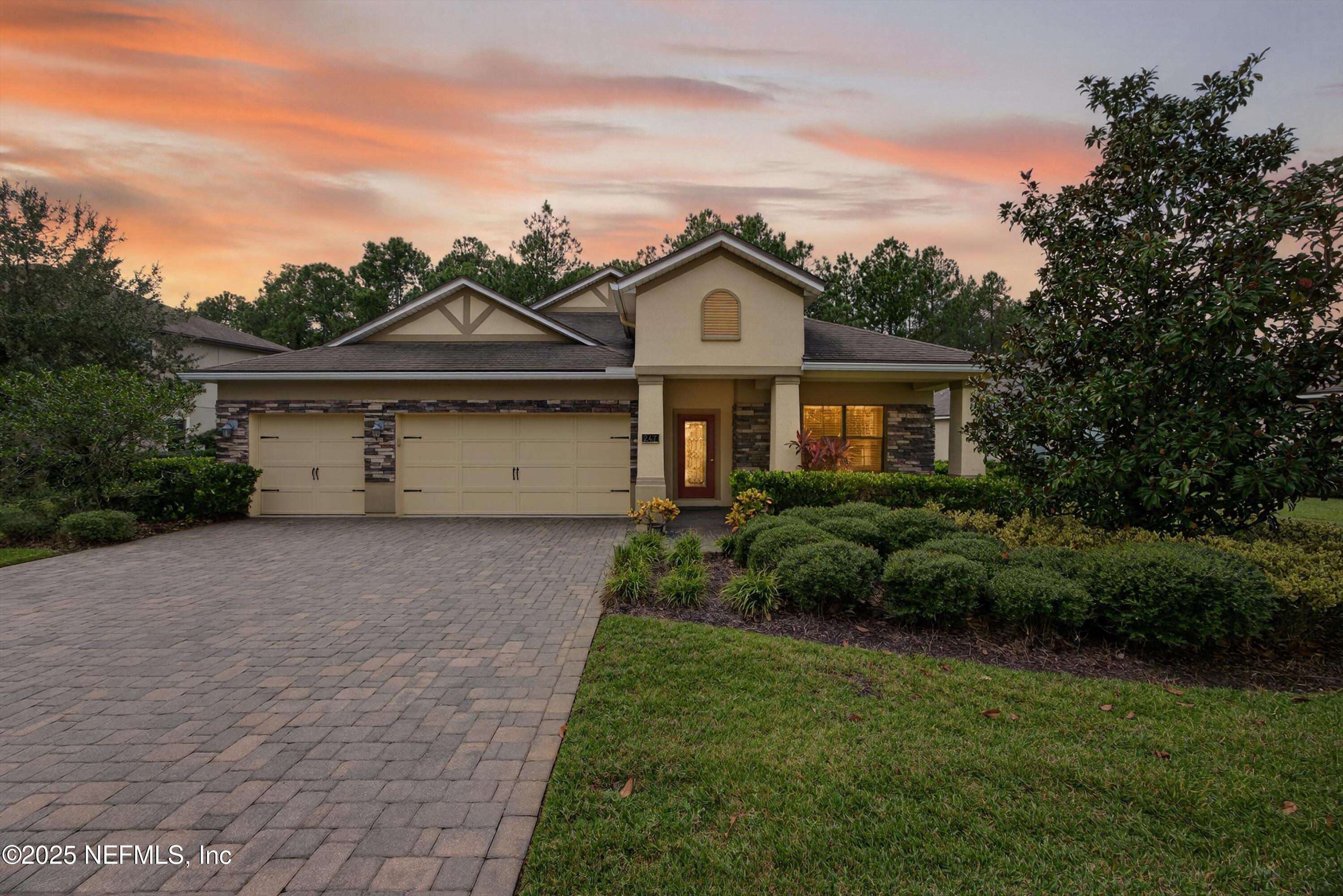 a front view of a house with a garden and plants