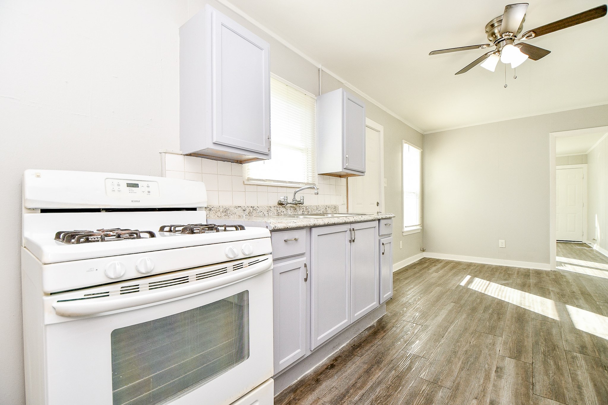 5000 Noble Street, Unit 6 Houston, TX 77020 - Photo 7 of 21 a kitchen with a stove oven and white cabinets