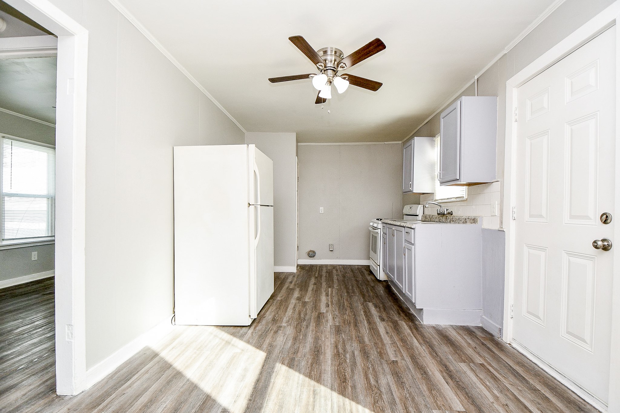 5000 Noble Street, Unit 6 Houston, TX 77020 - Photo 9 of 21 a view of a kitchen with a sink dishwasher and wooden floor