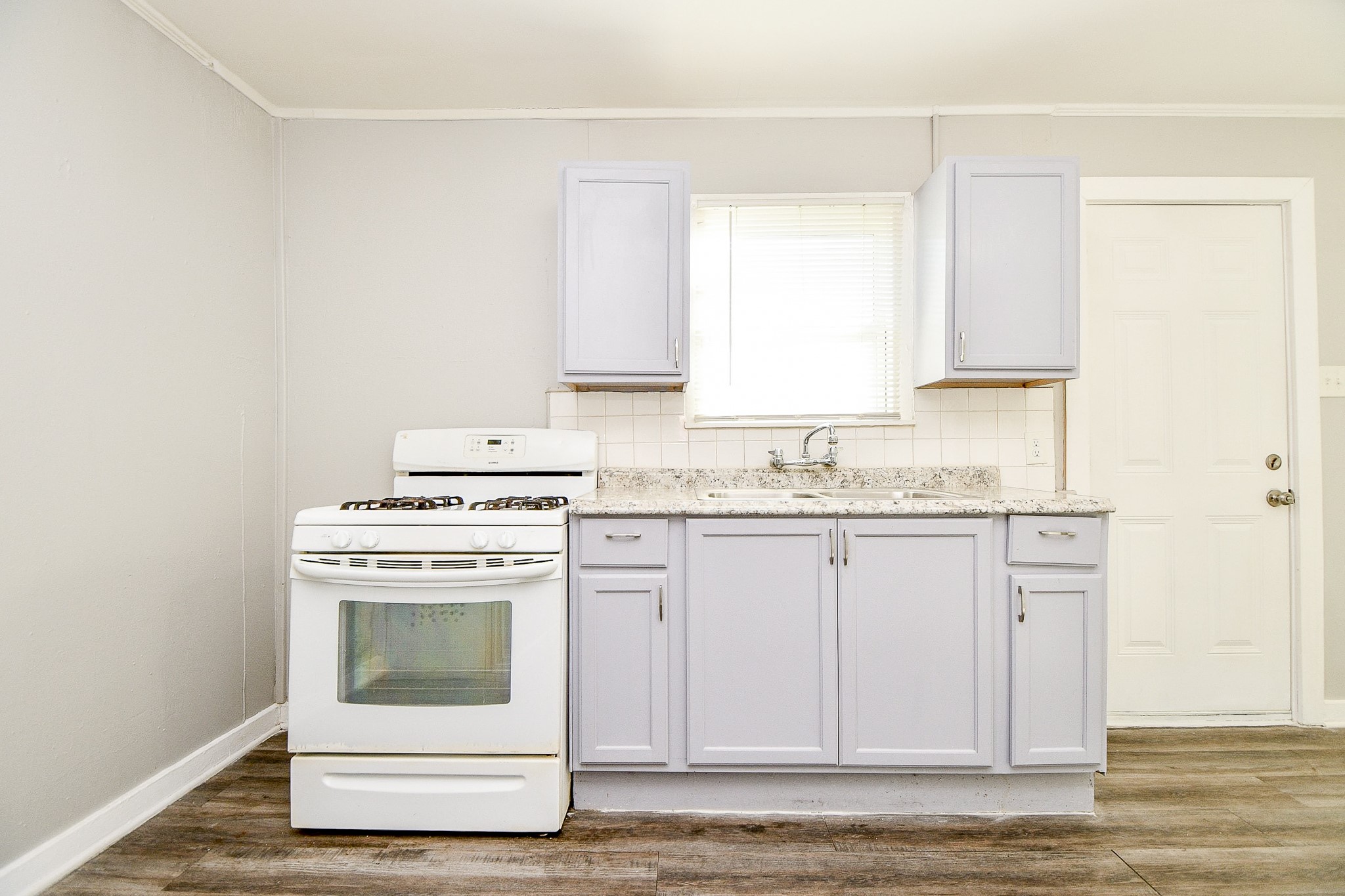 5000 Noble Street, Unit 6 Houston, TX 77020 - Photo 10 of 21 a kitchen with granite countertop cabinets stainless steel appliances and a sink