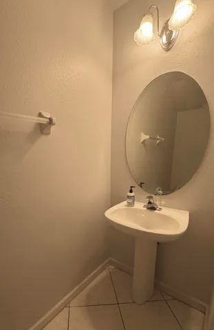 a kitchen with kitchen island granite countertop a sink a counter top space appliances and cabinets