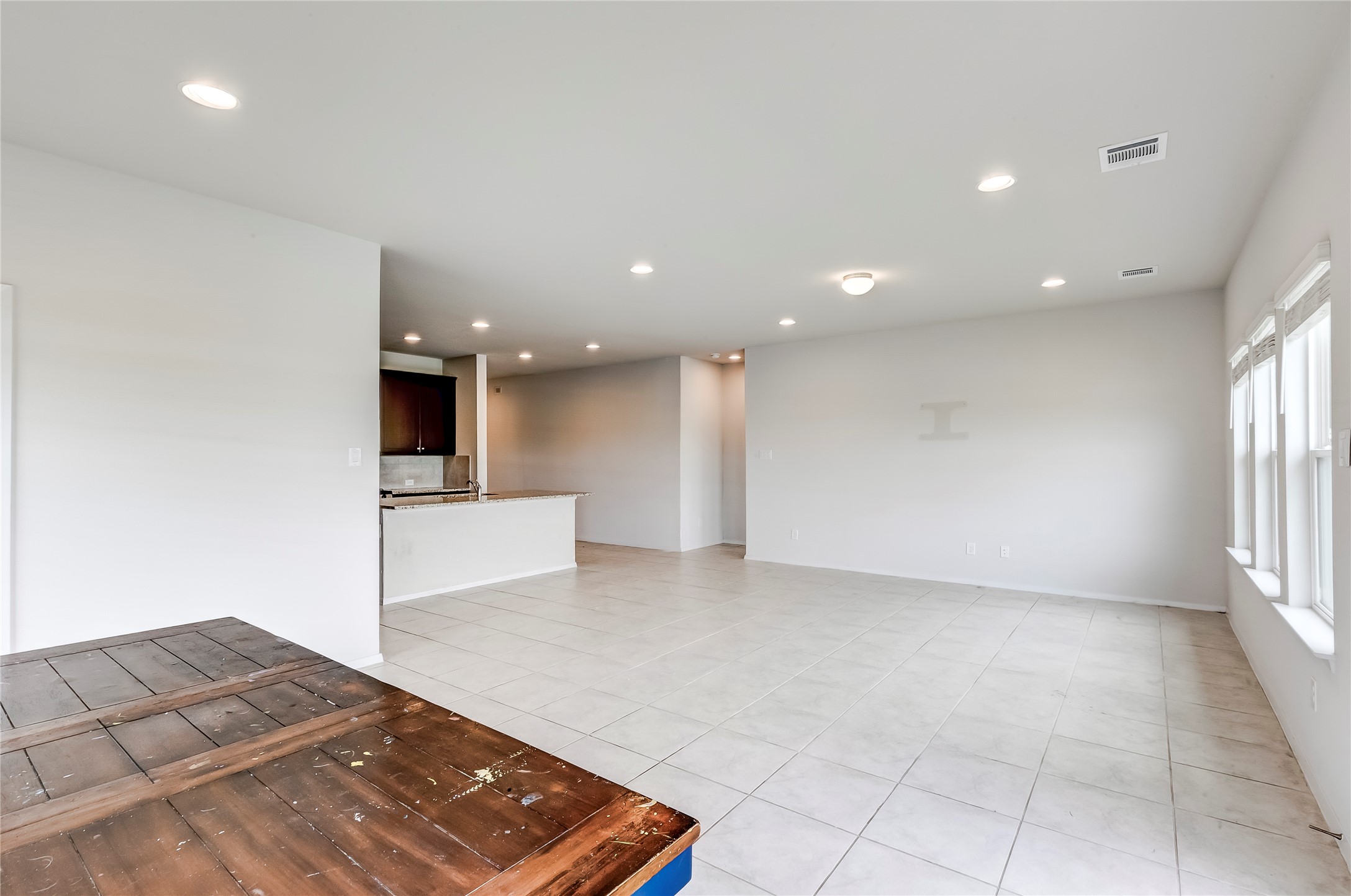 2721 Winding Creek Road Kyle, TX 78640 - Photo 13 of 27 Spacious open-concept living area featuring light-toned tile flooring throughout