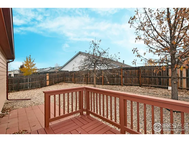 a view of balcony with wooden floor and fence