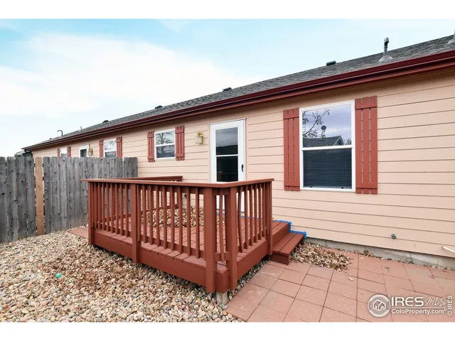 a view of a house with a small yard and wooden floor