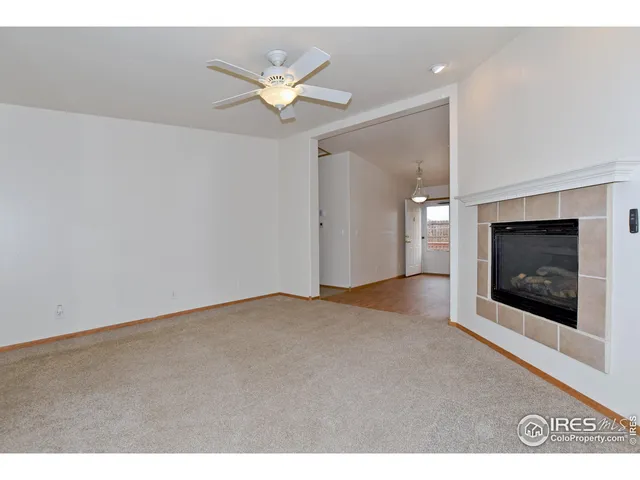 a view of empty room with window and fireplace