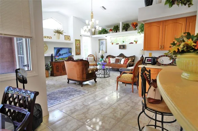 a living room with furniture and a dining table