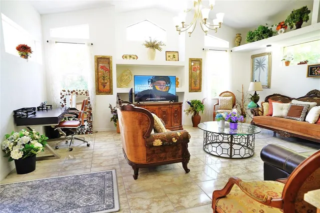 a living room with furniture and a chandelier