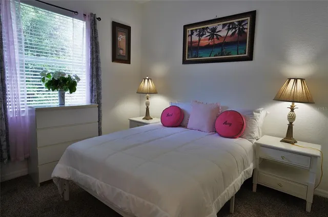 a bedroom with a bed and a mirror