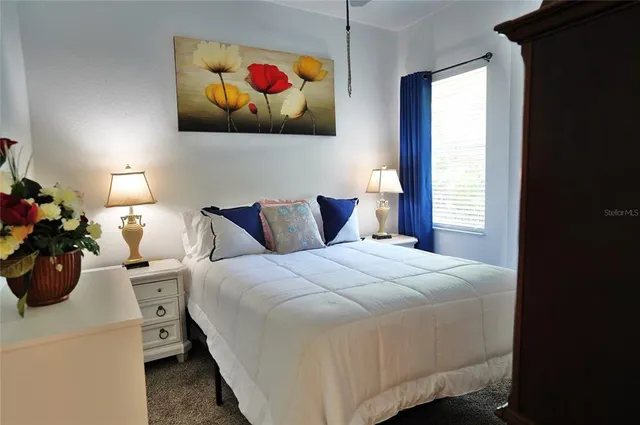 a bedroom with a bed and a dresser in it