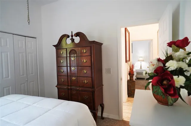 a bedroom with a bed gym equipment and a flat screen tv