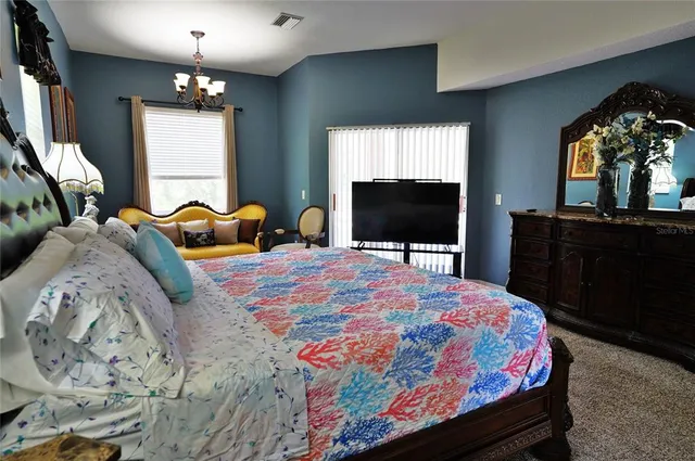 a bedroom with bed and wooden floor